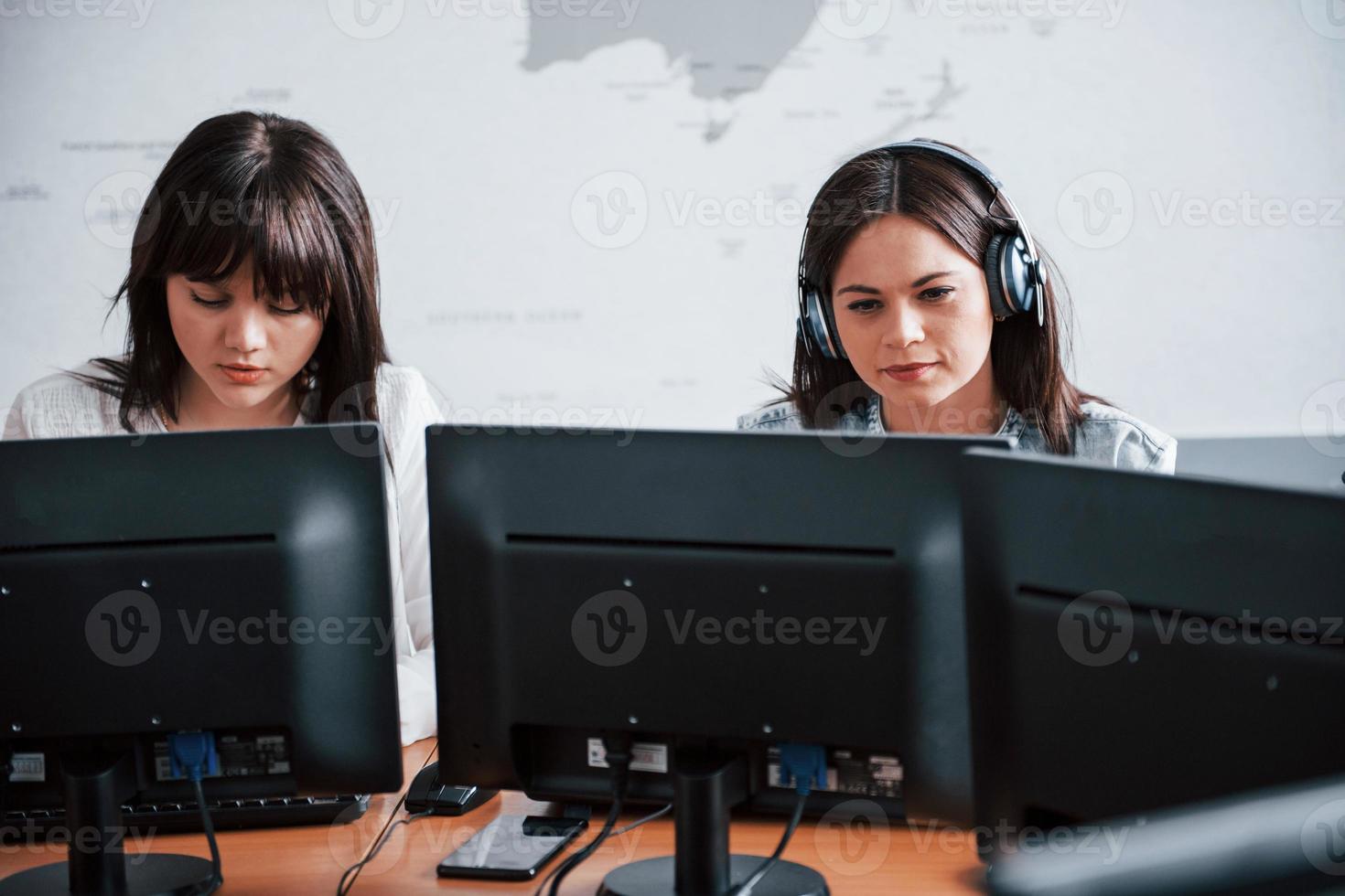 Photo of two employees. Young people working in the call center. New deals is coming