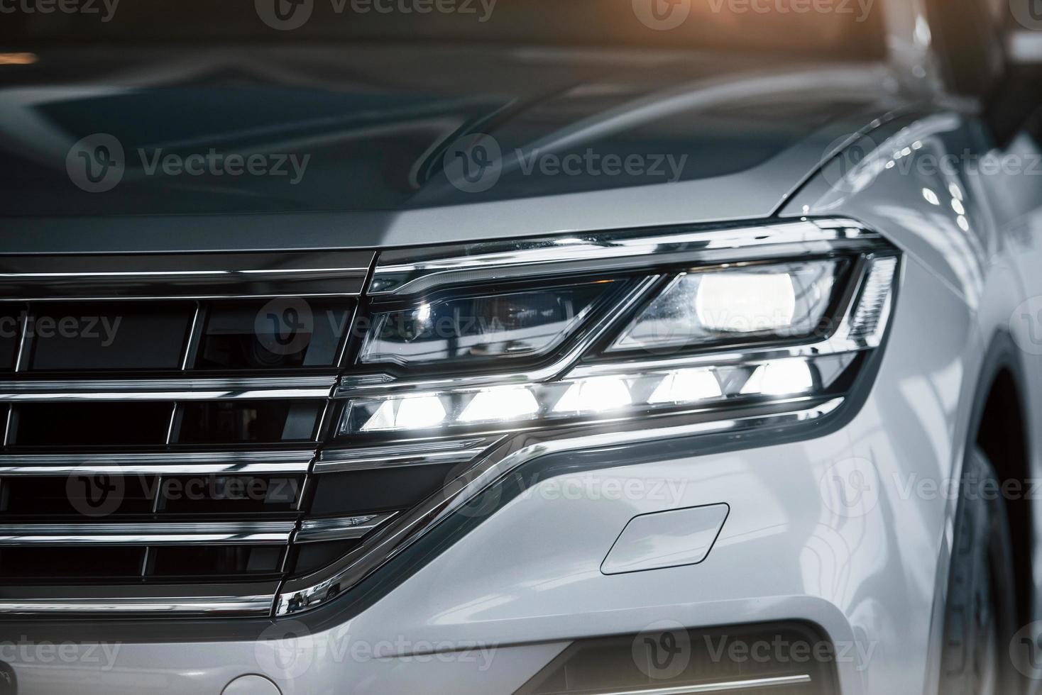 For successful people. Particle view of modern luxury white car parked indoors at daytime photo