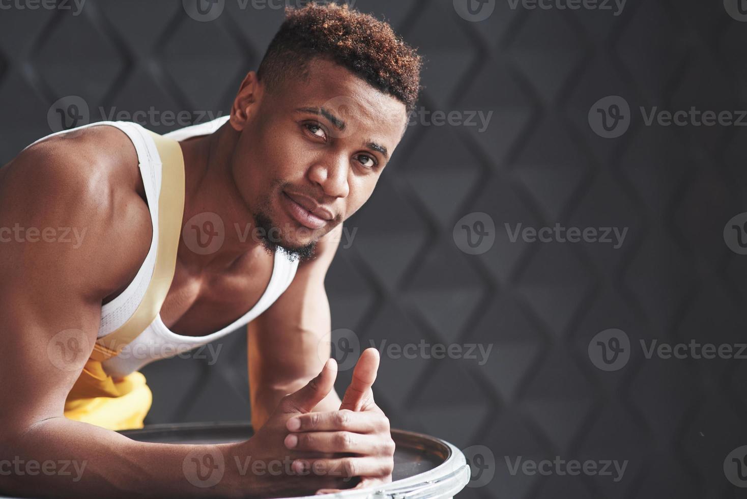 This man have strong hands. Young african american worker in the yellow uniform have some job photo