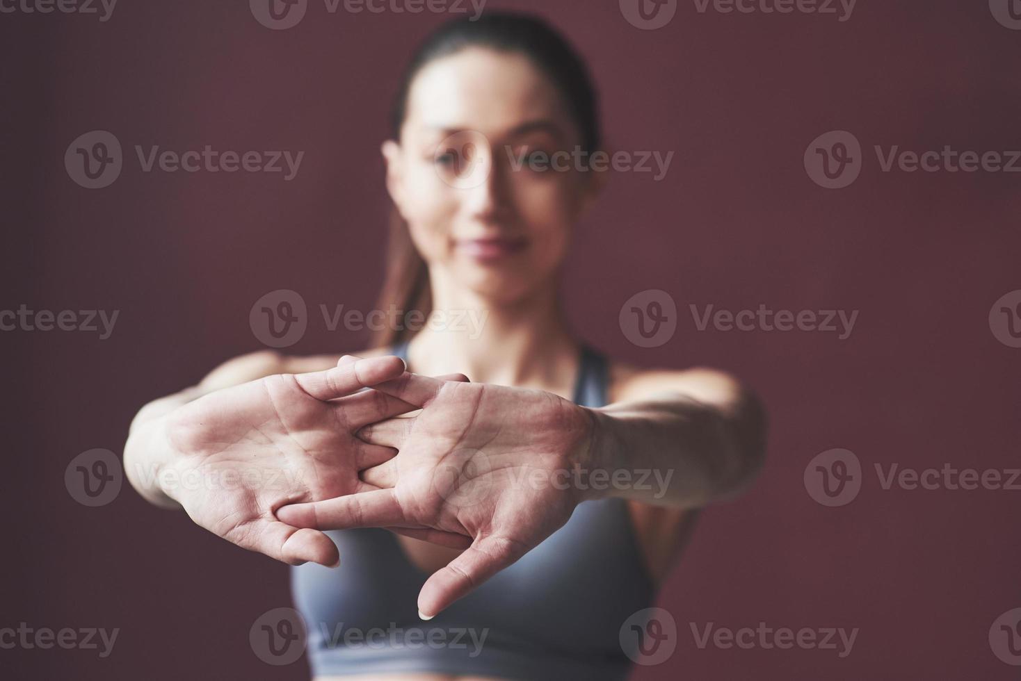 Don't forget to do warm ups. Girl with good fitness body type have exercises in the spacey room photo