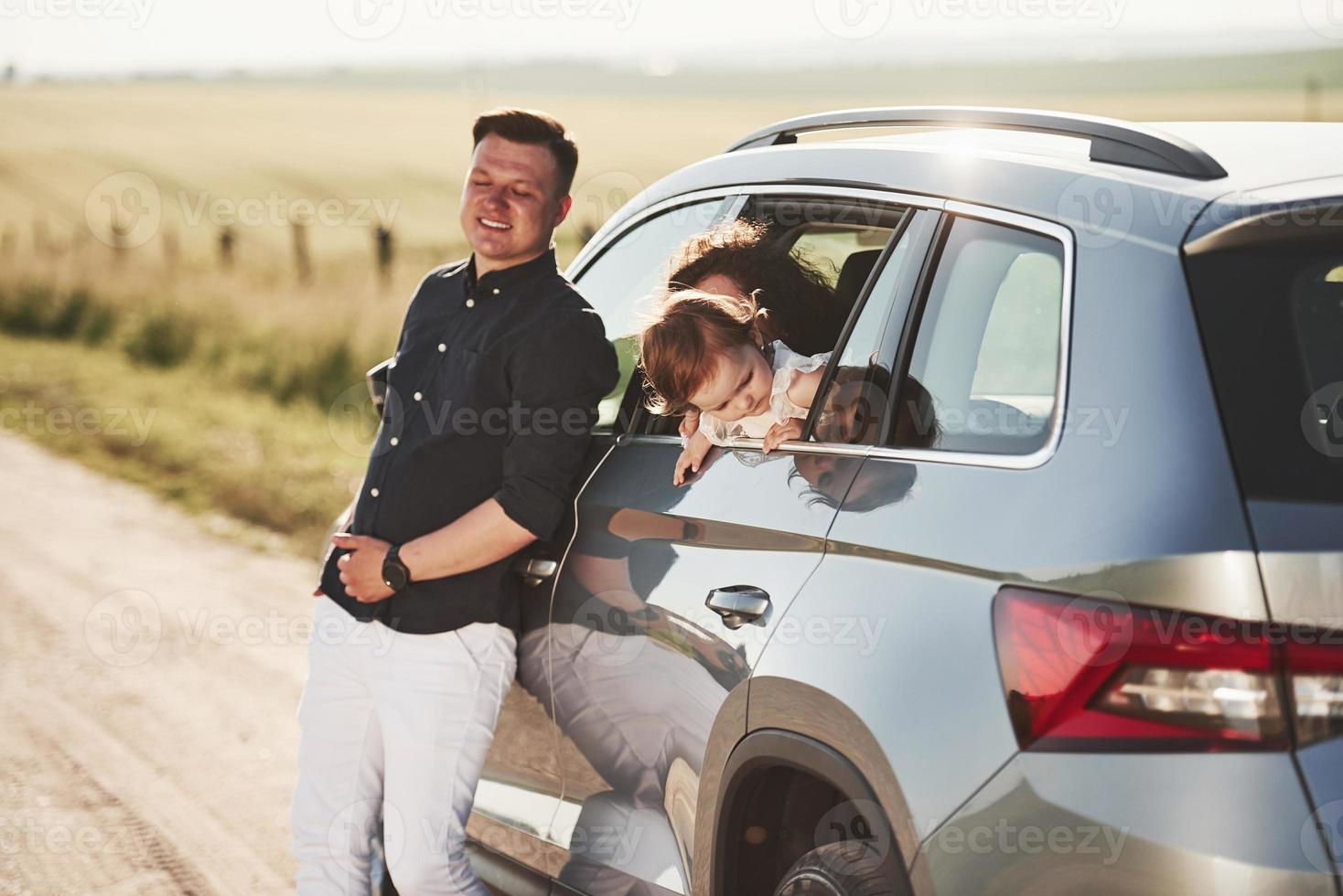 Taking a break. Beautiful people is in the modern car at their weekends photo