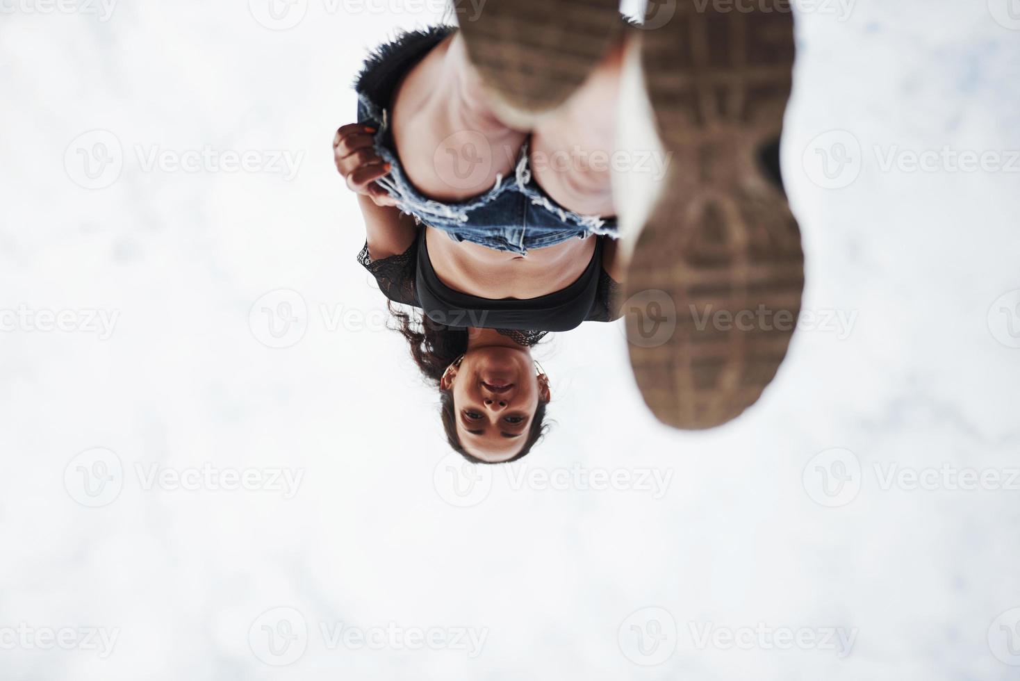 Woman in casual clothes stands on glass at daytime photo