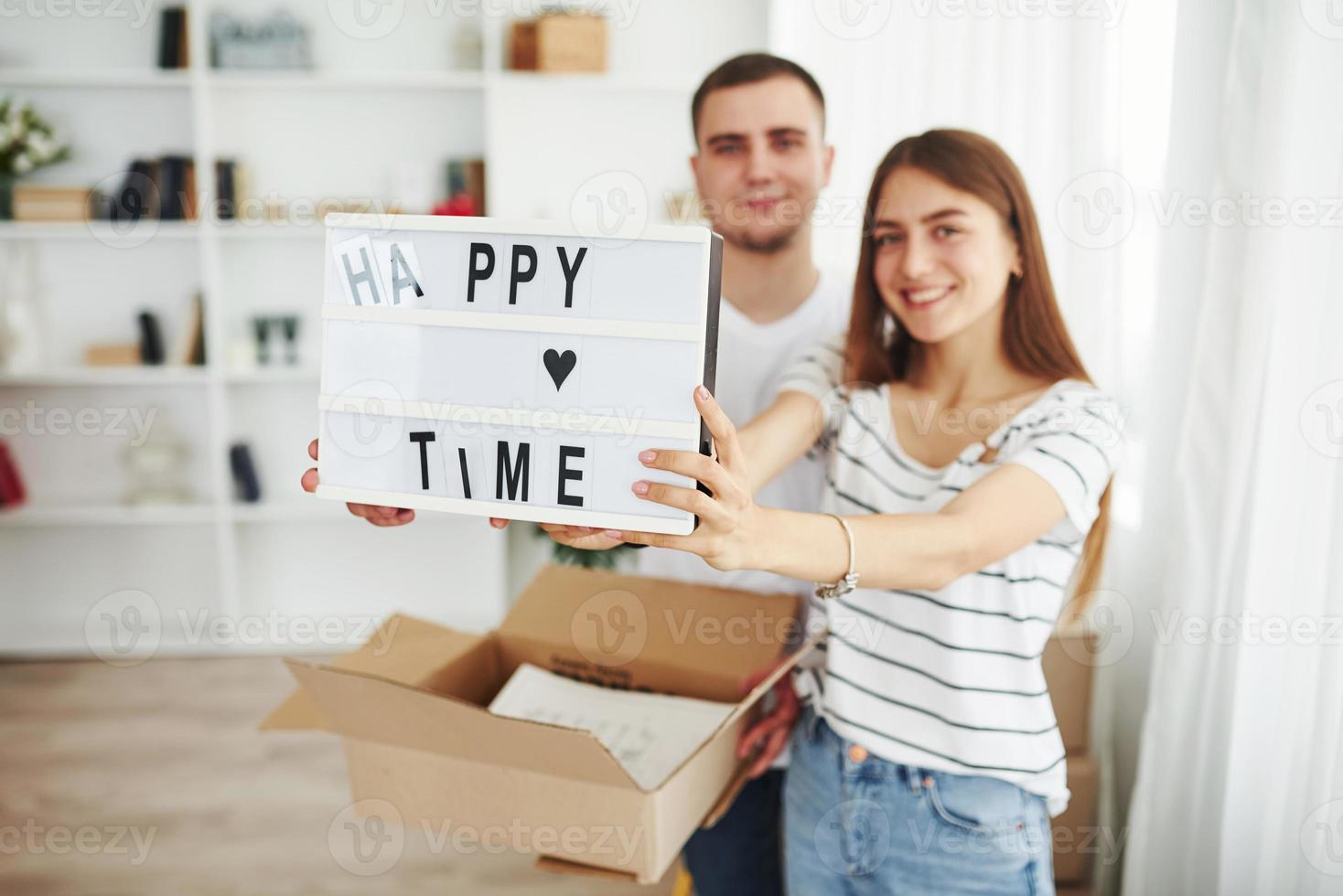 Cheerful young couple in their new apartment. Conception of moving photo