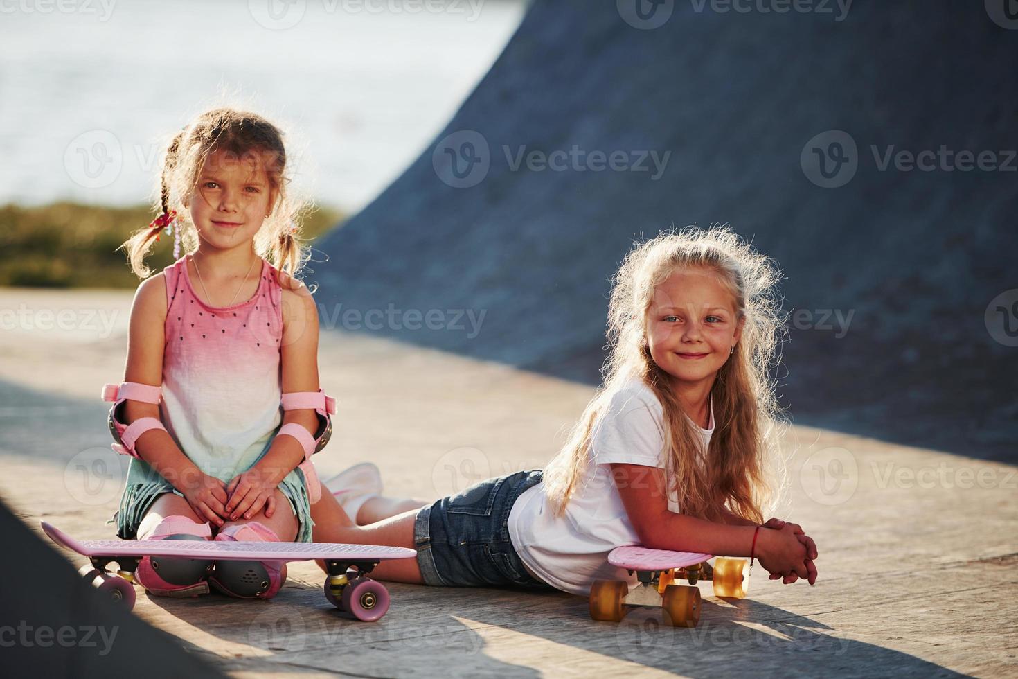 Posing for a camera. Unity of people. Two little friends in the park at daytime photo