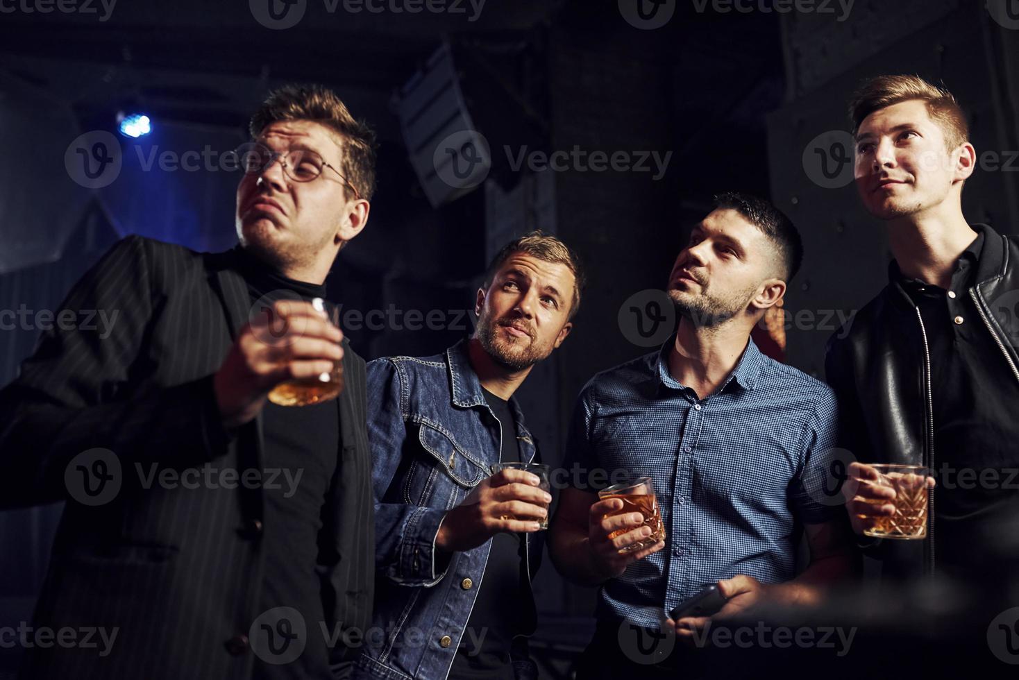 Conception of nightlife. People have fun in the club. With alcohol in hands photo