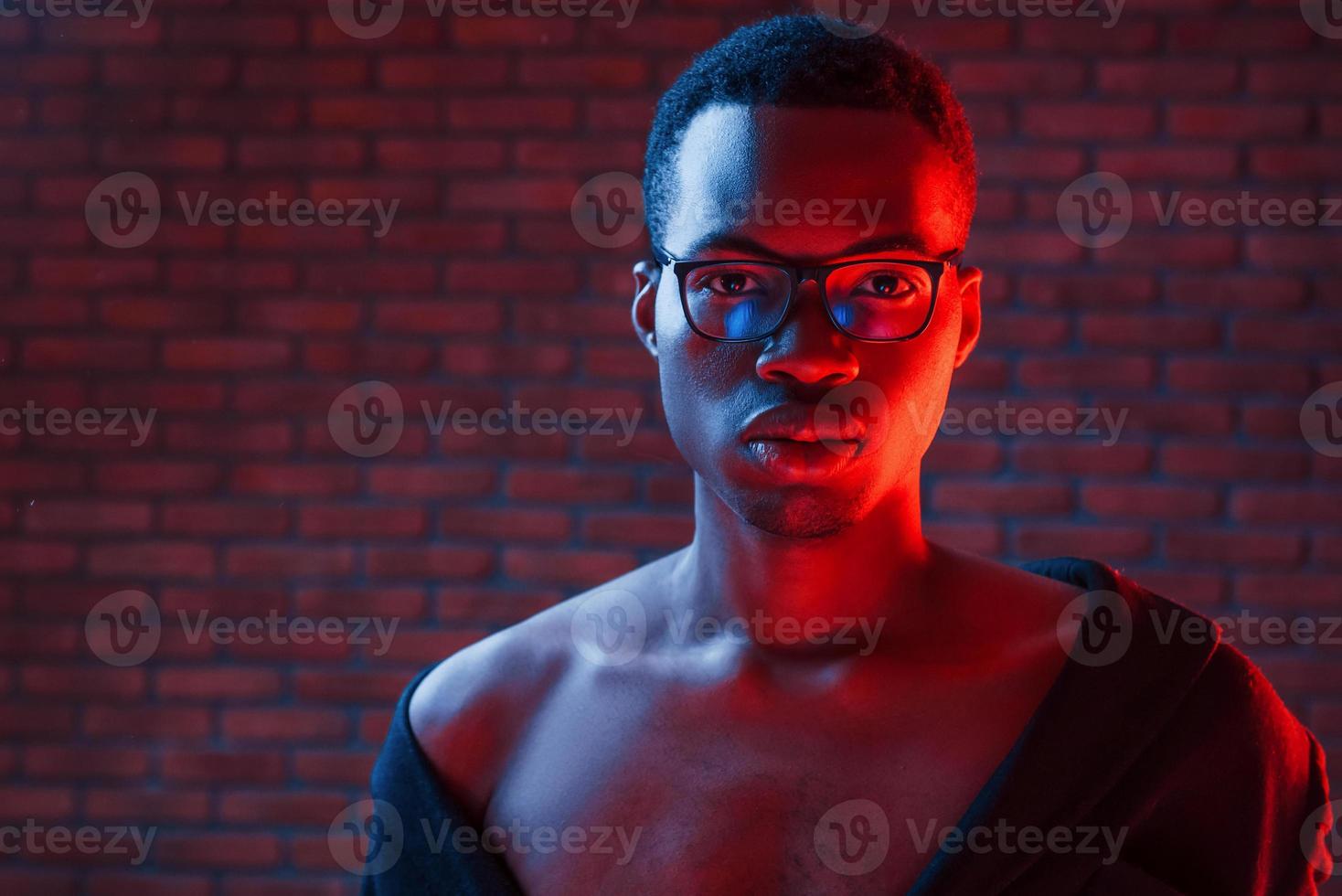 Futuristic neon lighting. Young african american man in the studio photo