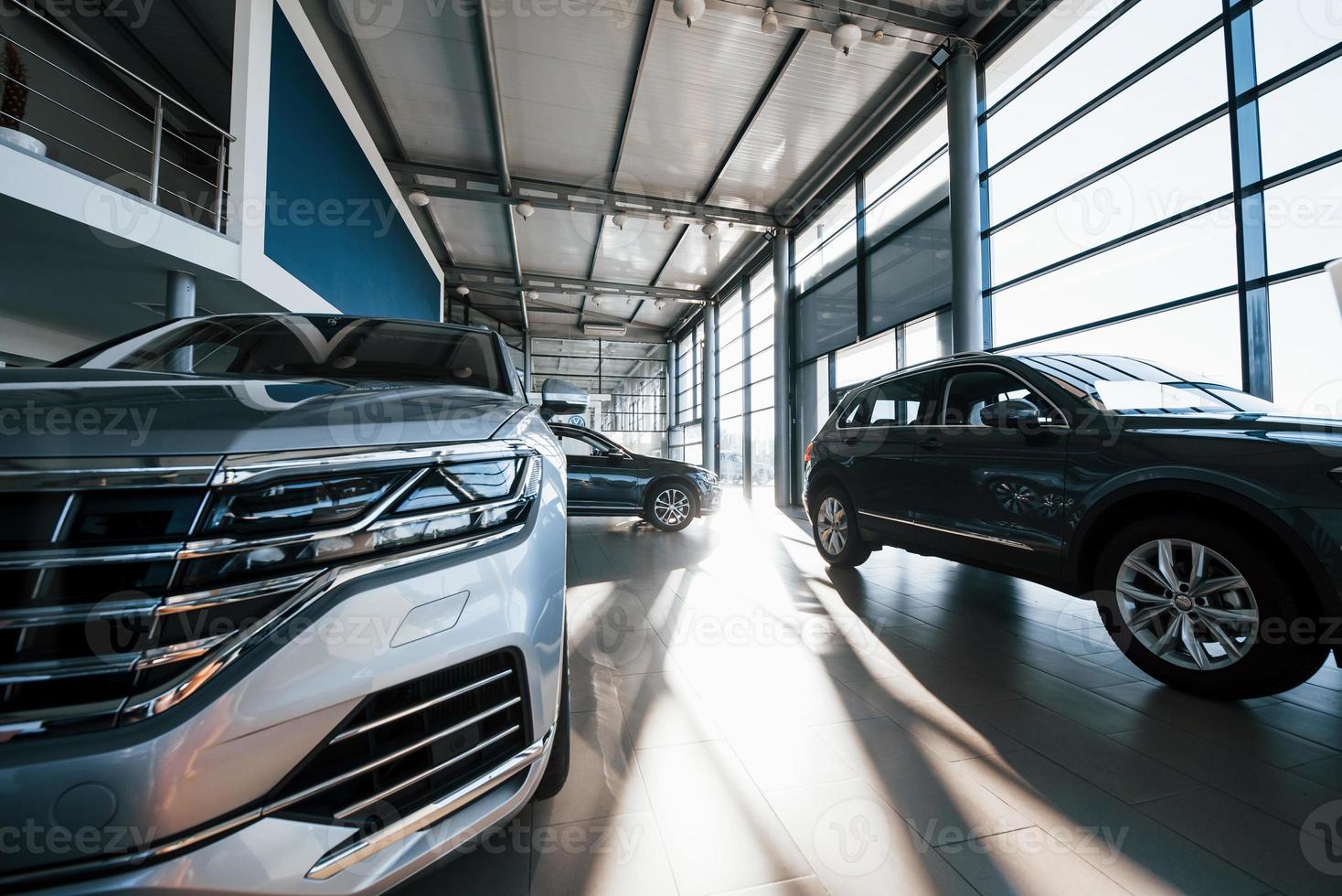 Brand new cars at dealer showroom. Perfectly polished. Natural lighting photo