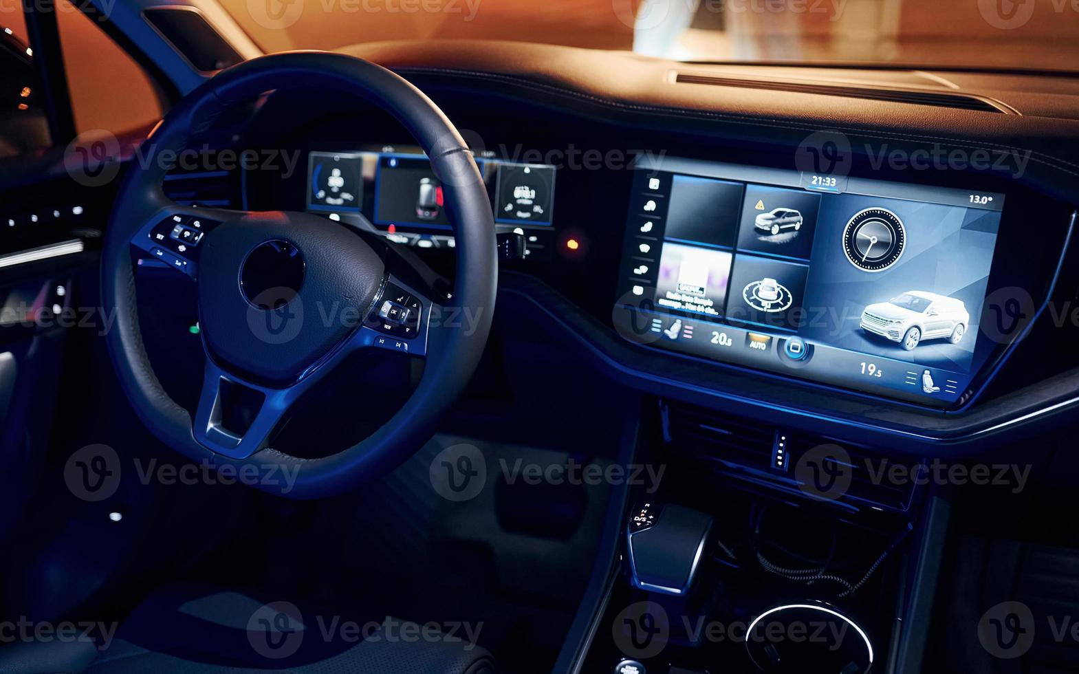 Steering wheel and navigation display. Close up view of front park of new modern black automobile photo