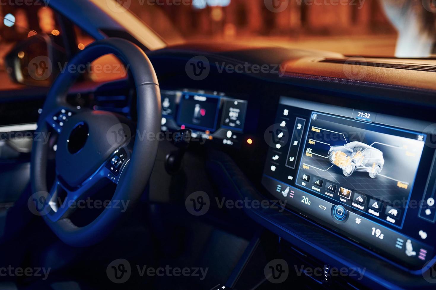 Steering wheel and navigation display. Close up view of front park of new modern black automobile photo