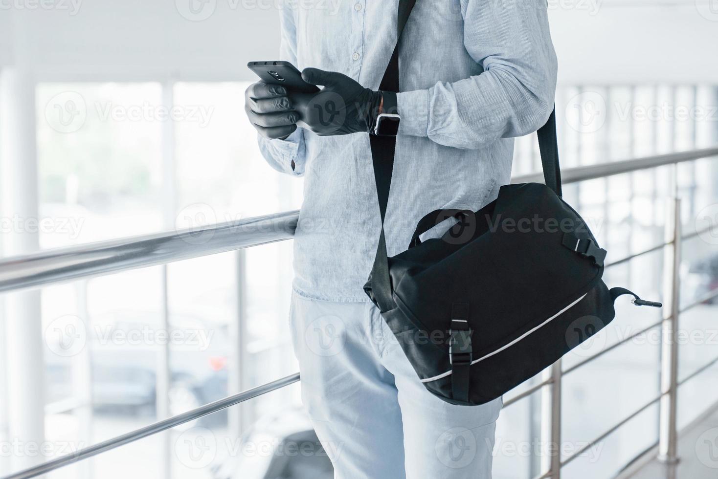 Close up view of young handsome man in formal clothes that indoors in the office at daytime photo