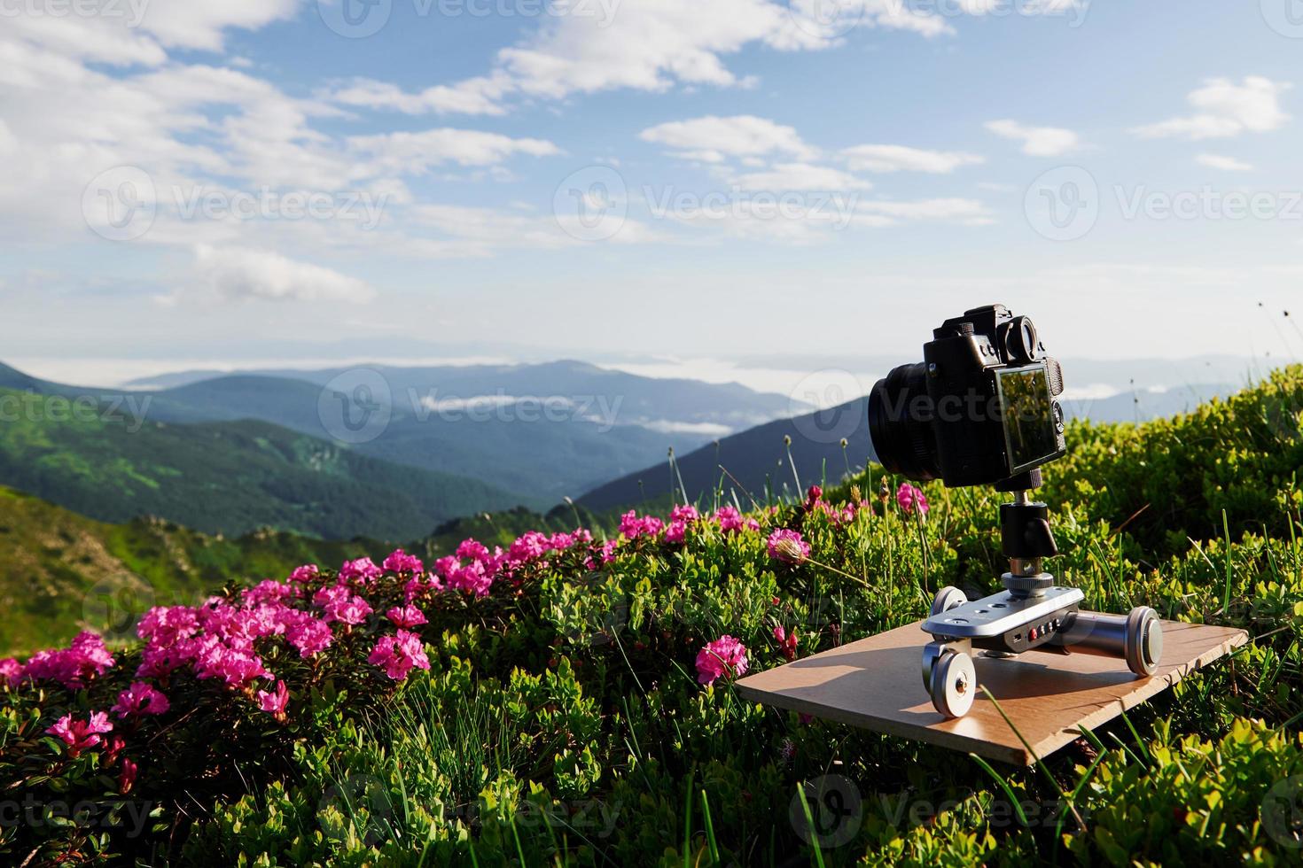 Professional camera stands on tripod. Majestic Carpathian mountains. Beautiful landscape. Breathtaking view photo