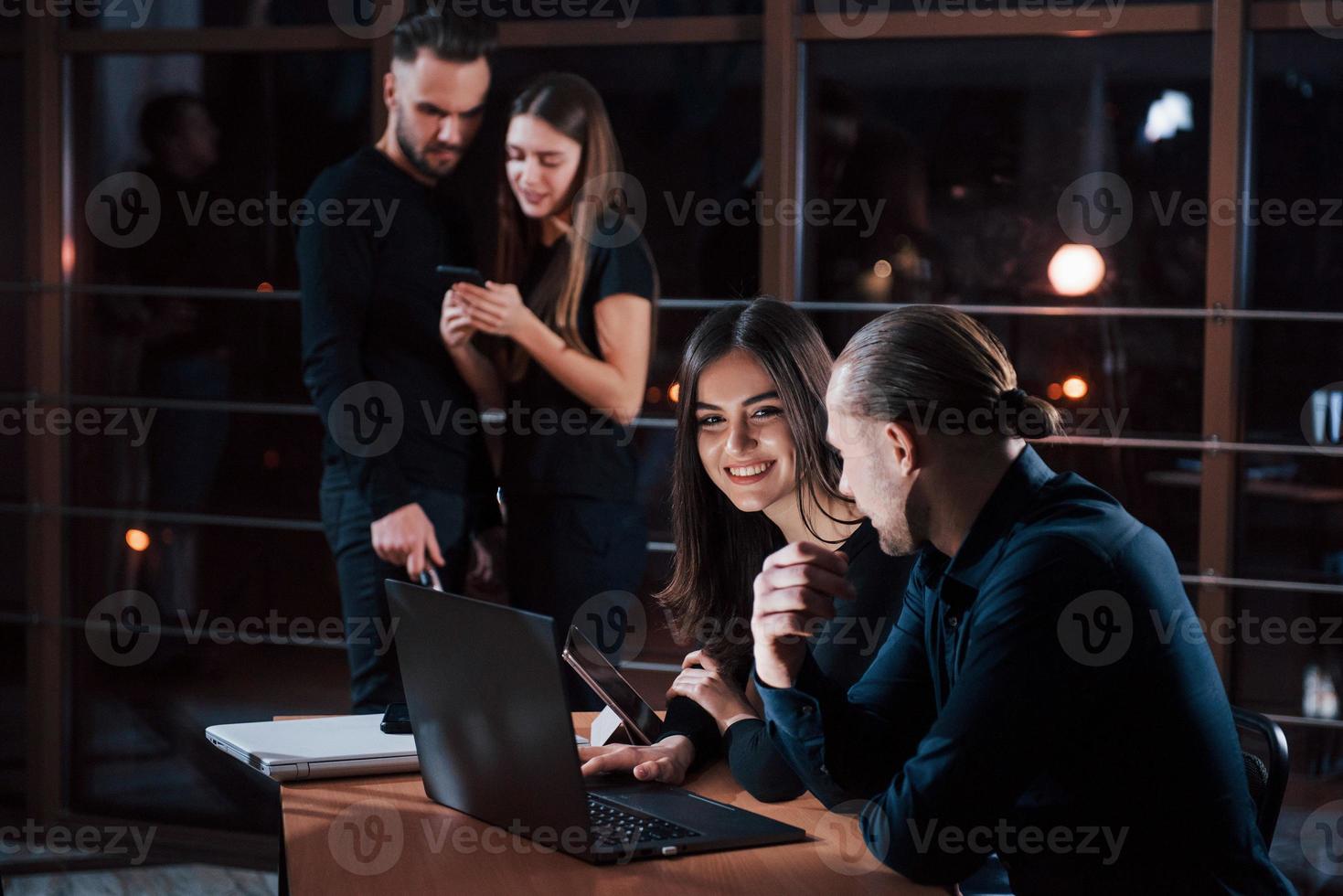 I understand what you tying to say. Team of young business people works on their project at night time in the office photo