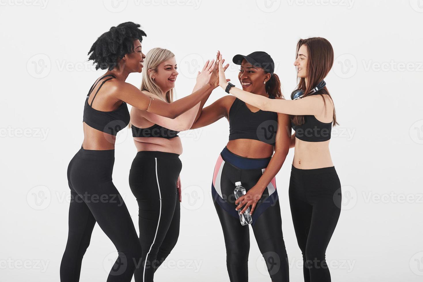 Together is easier. Group of multi ethnic women standing in the studio against white background photo