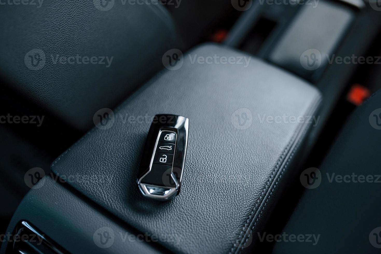 Single object. Close up photo of keys lying donw inside brand new modern car