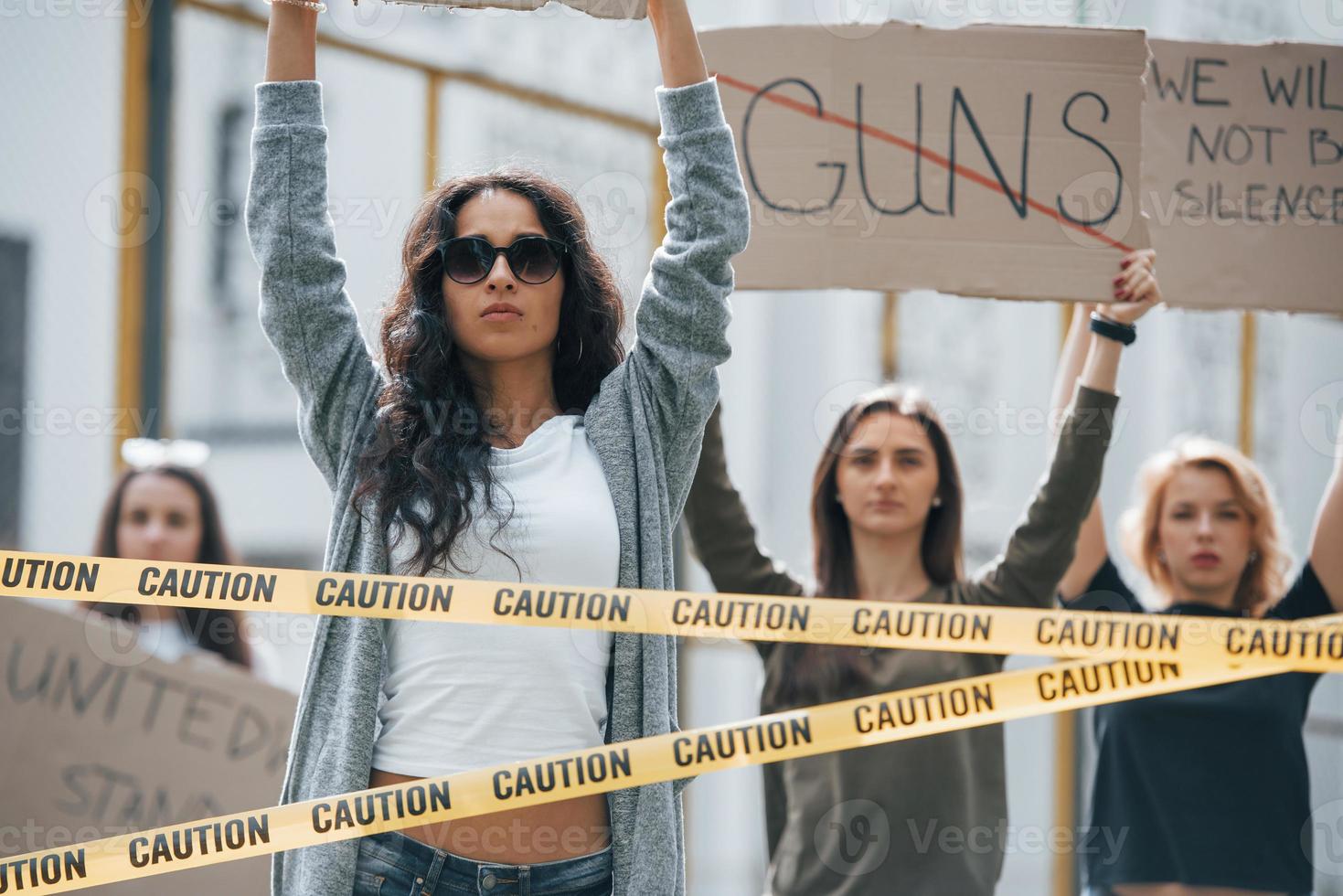 Word guns is crossed out. Group of feminist women have protest for their rights outdoors photo