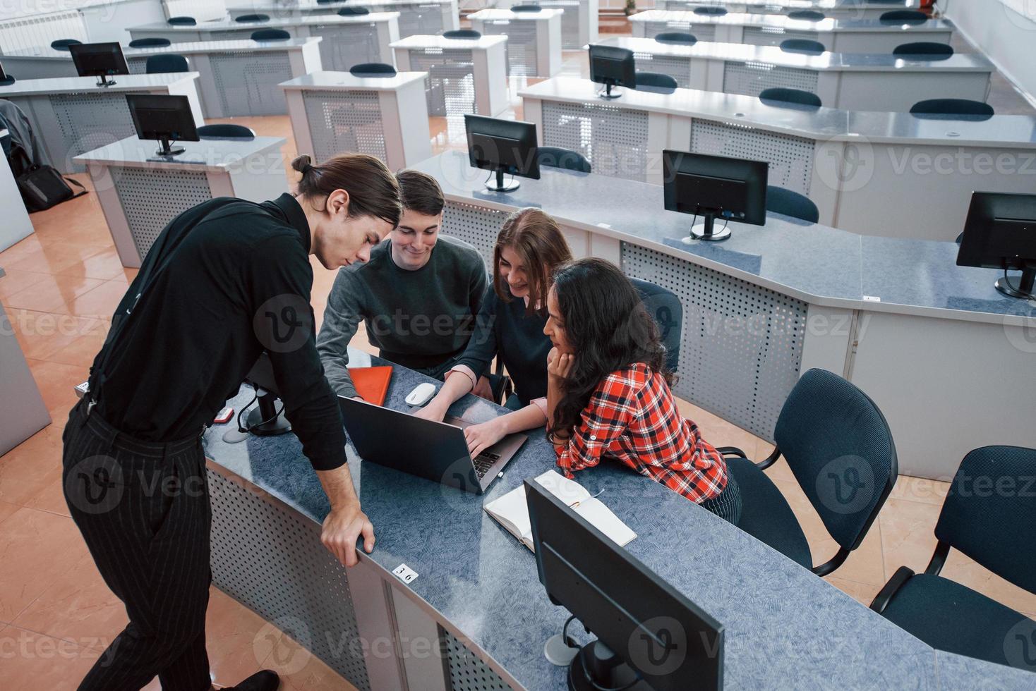 What do you have today. Group of young people in casual clothes working in the modern office photo