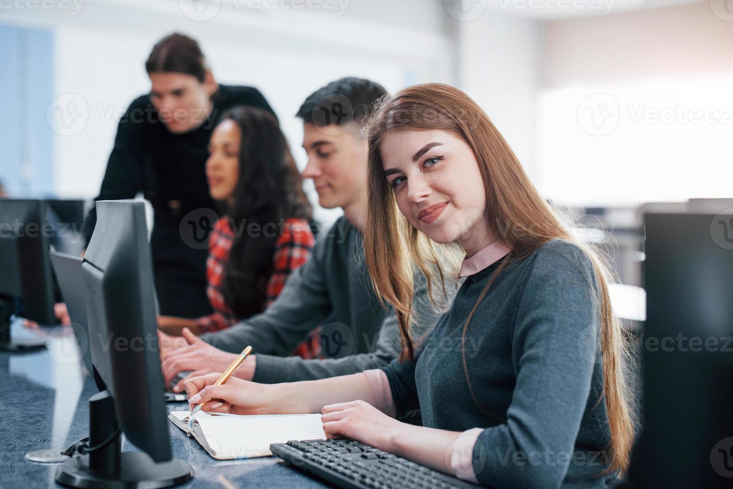 I love my work. Group of young people in casual clothes in the modern office photo