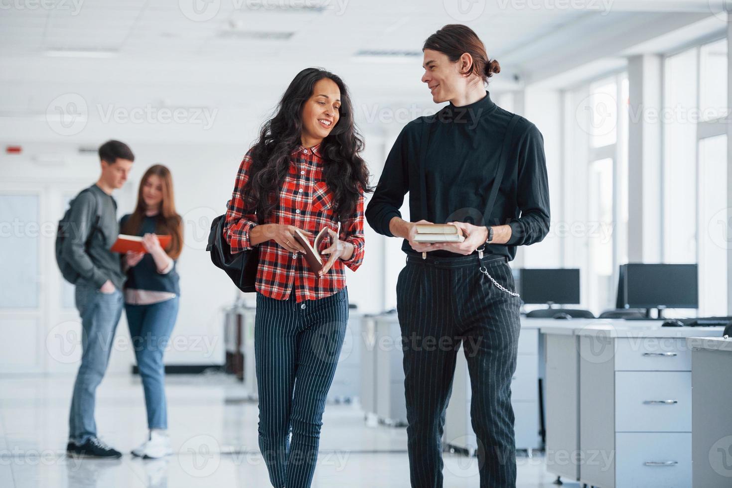 I have good plan. Group of young people walking in the office at their break time photo