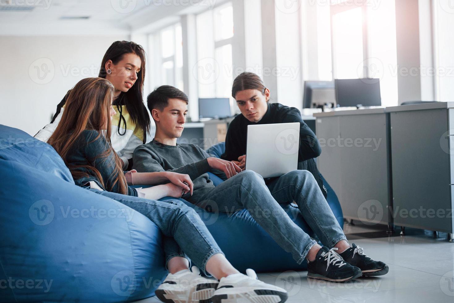 This one's looks nice. Group of young people in casual clothes working in the modern office photo