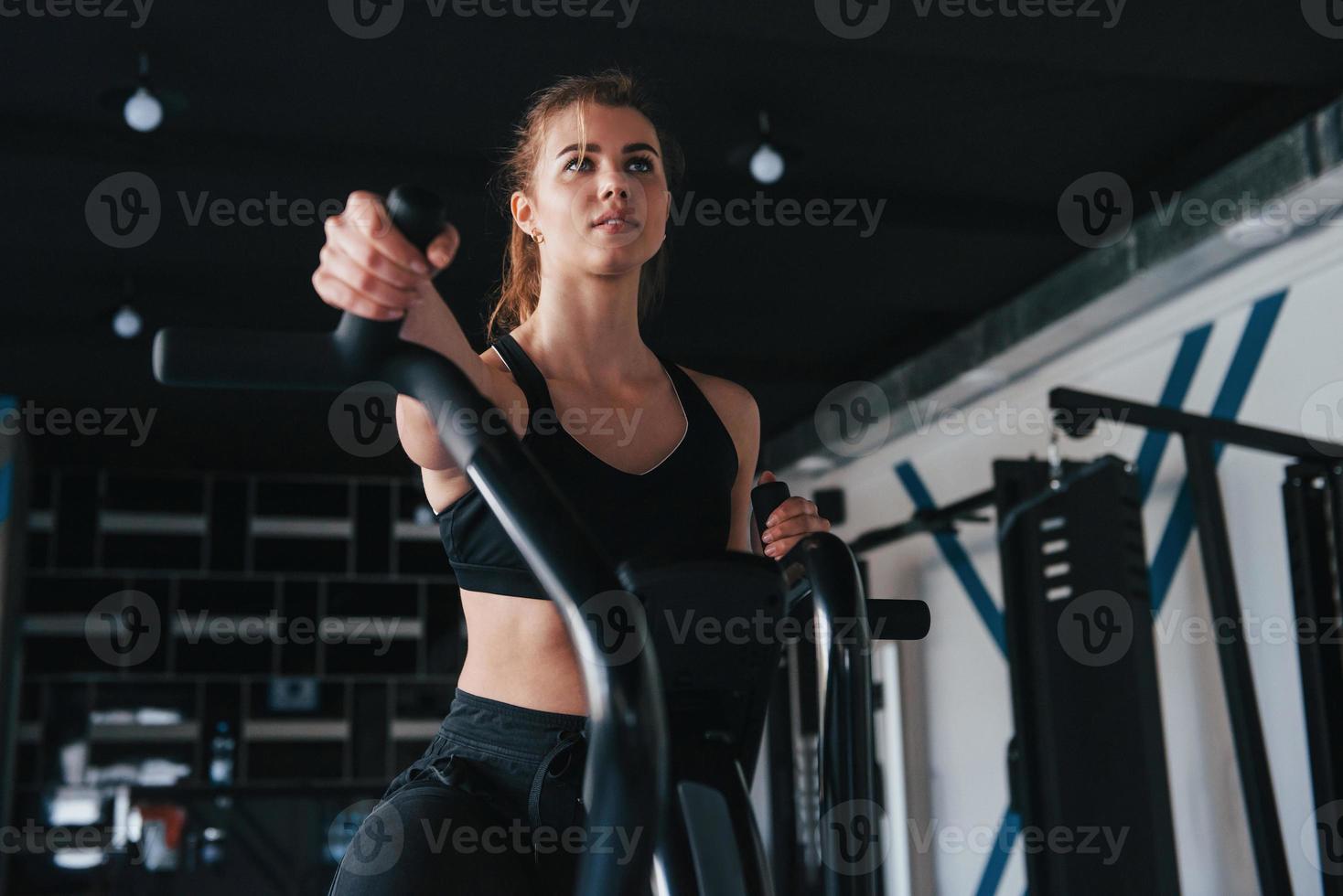 Cycling and feeling good. Photo of gorgeous blonde woman in the gym at her weekend time