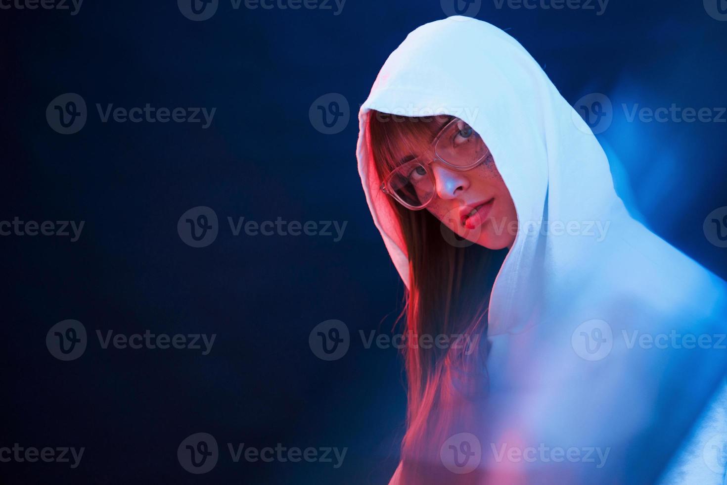 Attractive woman. Studio shot in dark studio with neon light. Portrait of young girl photo