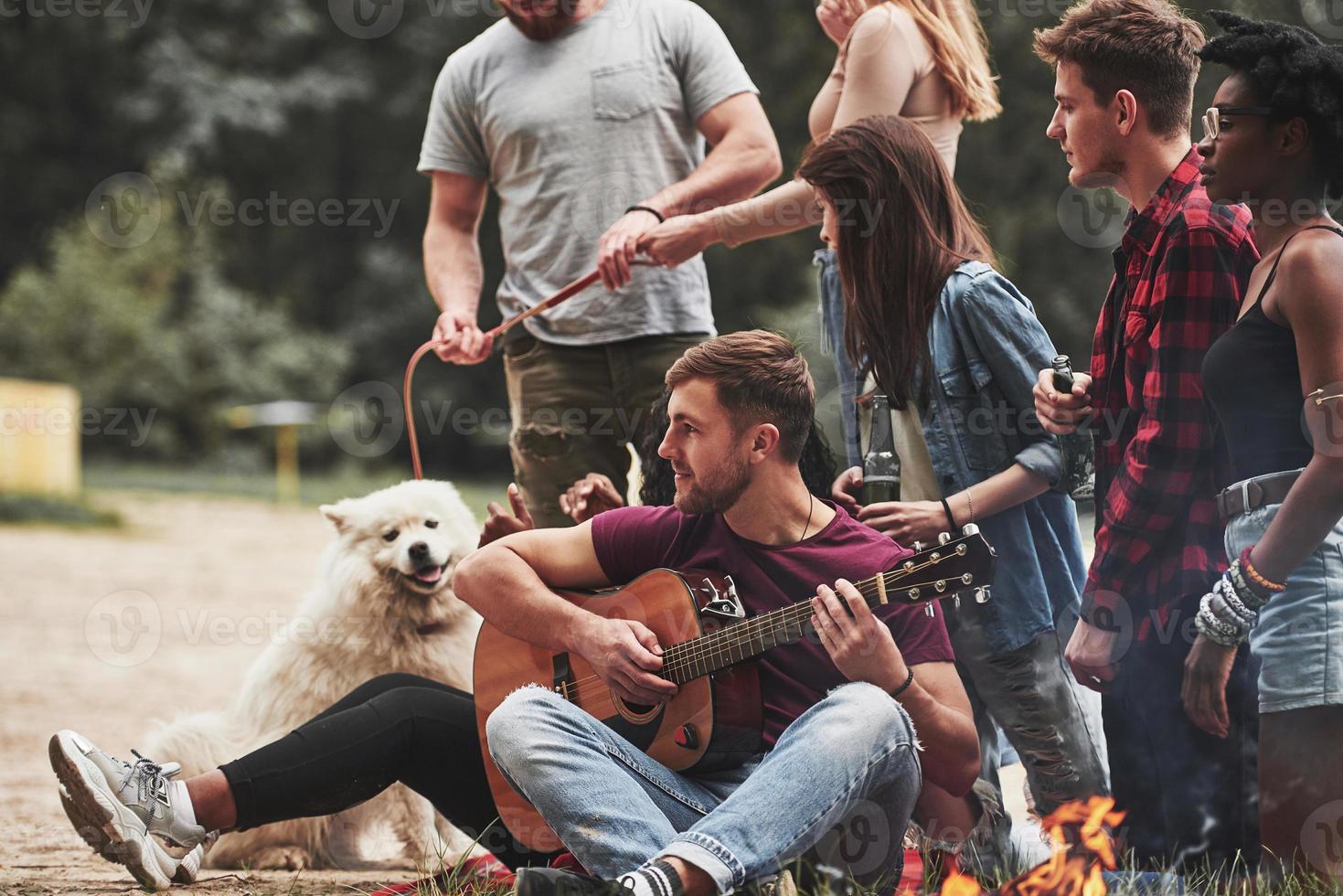 Awesome nature. Group of people have picnic on the beach. Friends have fun at weekend time photo