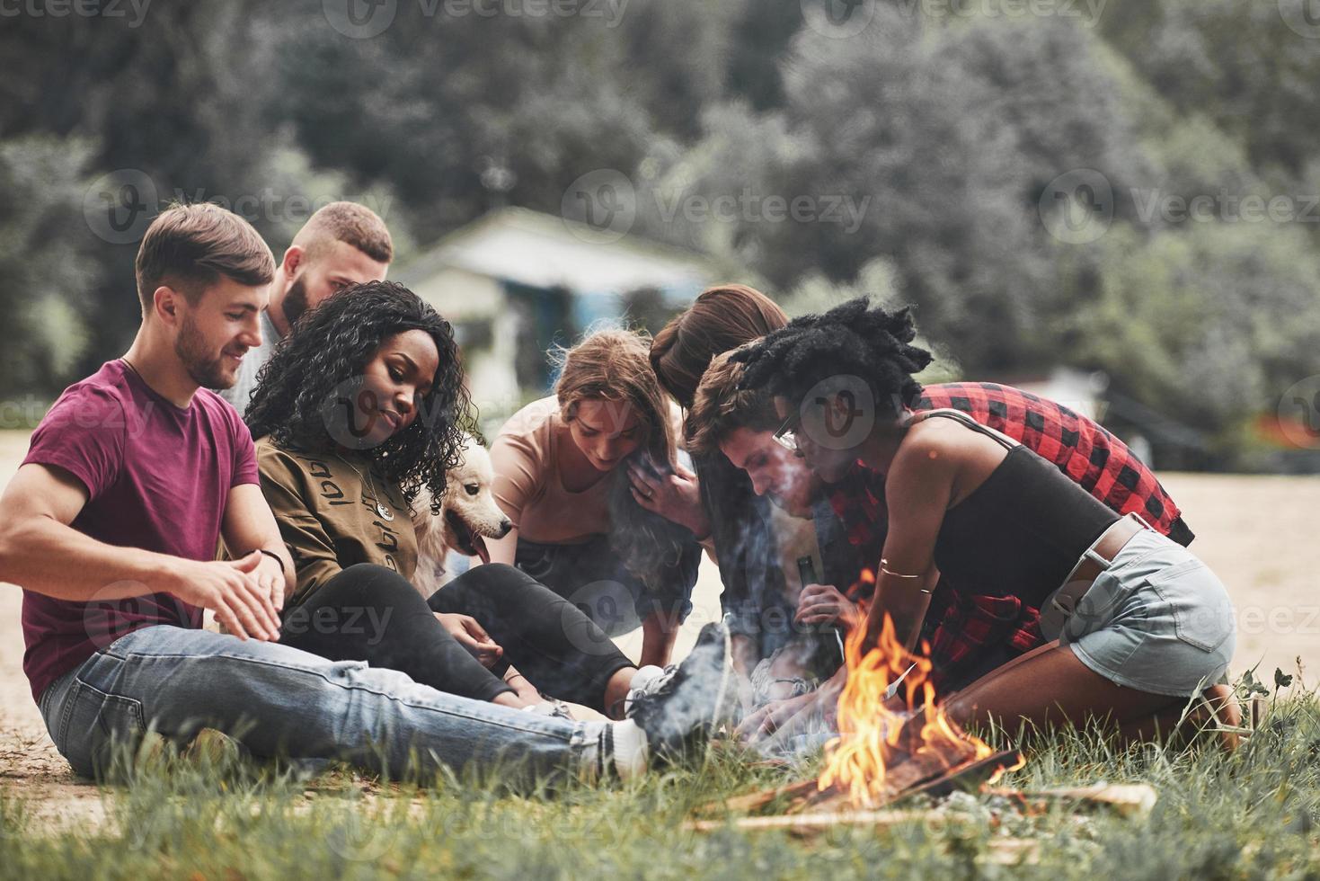 algún tipo de juego. mirando abajo. grupo de personas hacen picnic en la playa. los amigos se divierten el fin de semana foto