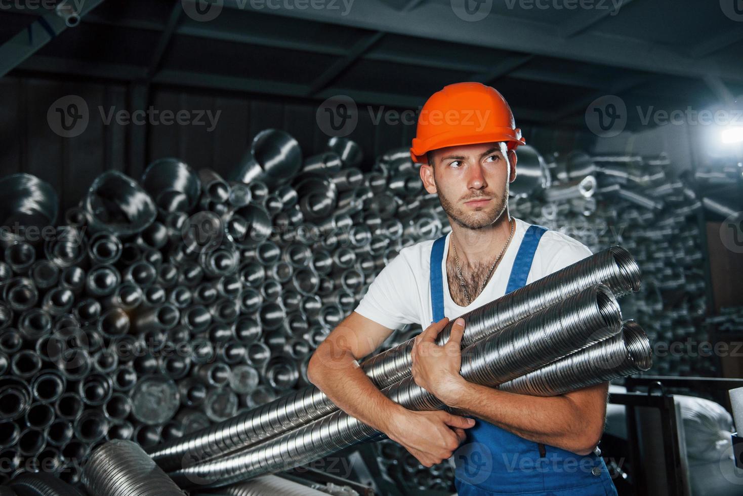 Artificial lighting. Man in uniform works on the production. Industrial modern technology photo