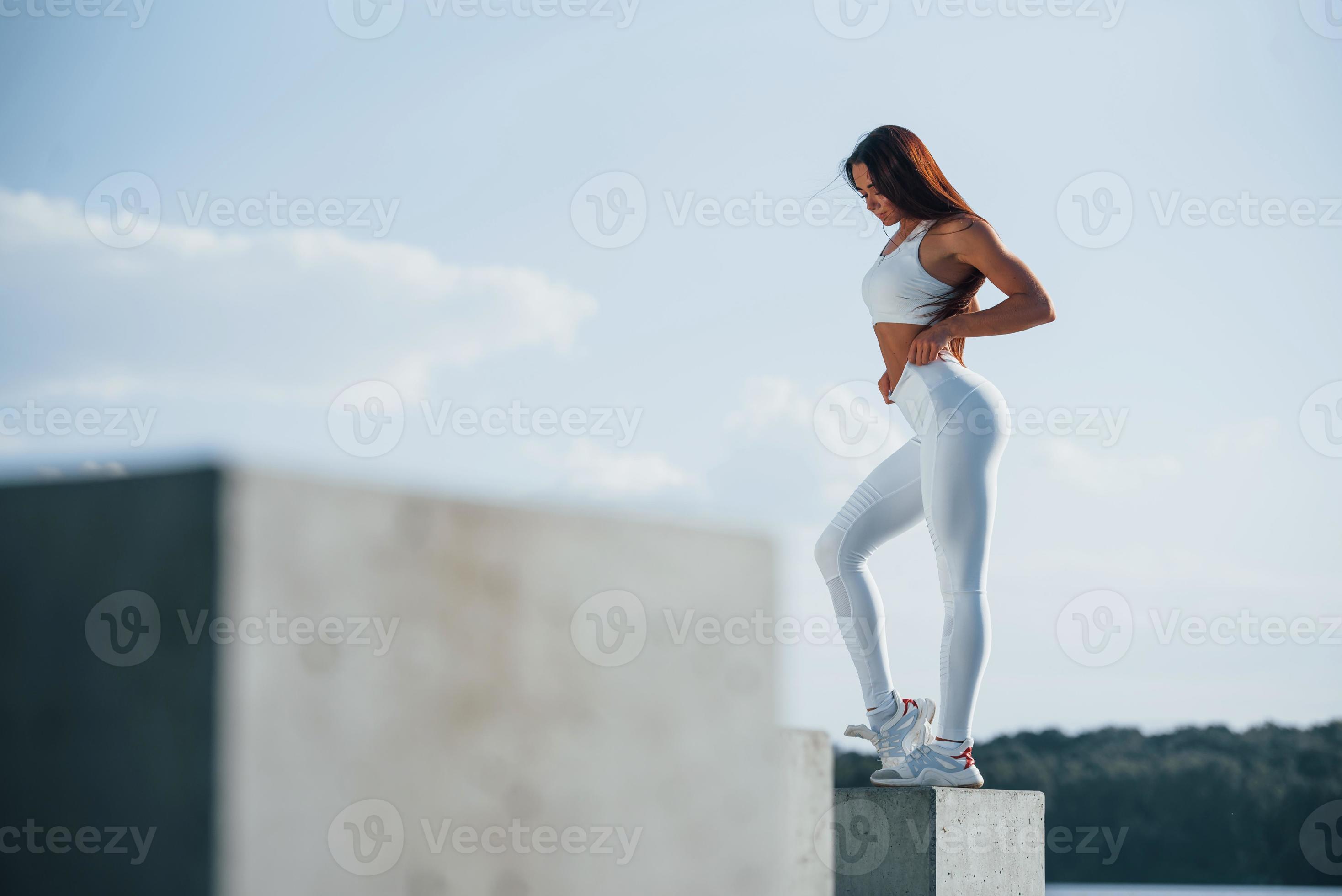 Posing for the camera. Young fitness woman with slim body type is outdoors  15220035 Stock Photo at Vecteezy