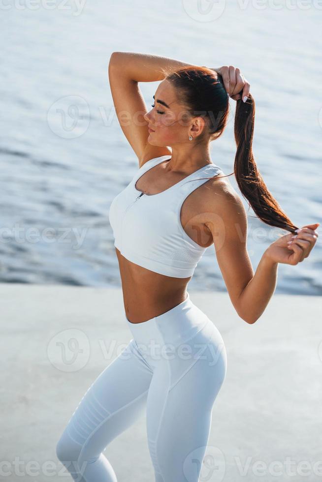 Posing for the camera. Young fitness woman with slim body type is outdoors  15220037 Stock Photo at Vecteezy