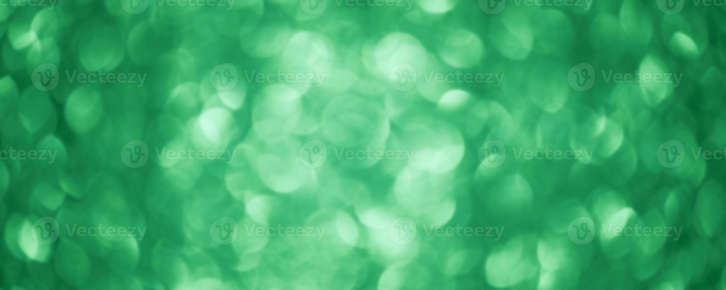 Green glitter background defocus light. Round defocuses on a blurred background. photo