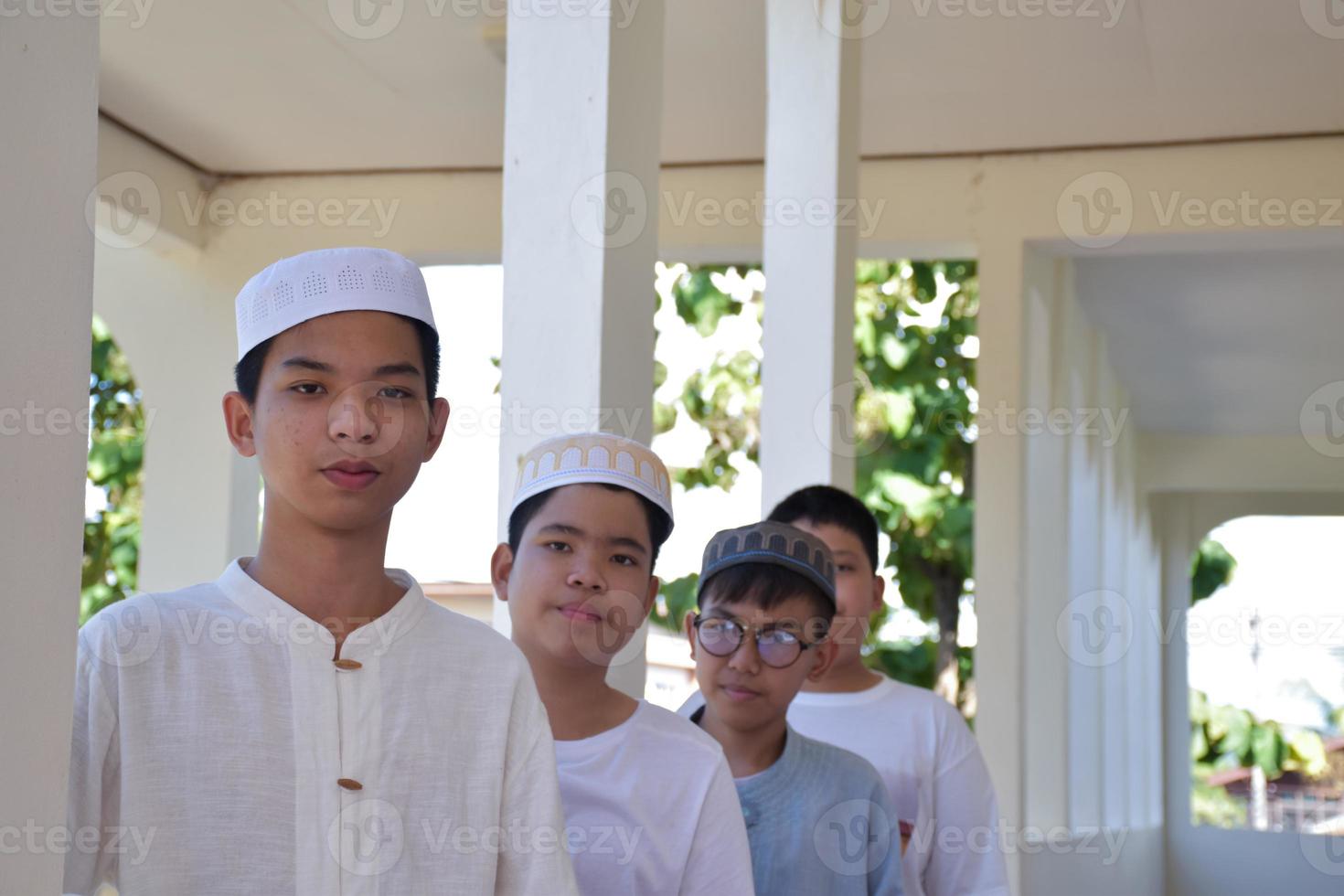 Young southeast asian children standing in a row in front of balcony and waiting to do their daily activity, soft and selective focus. photo