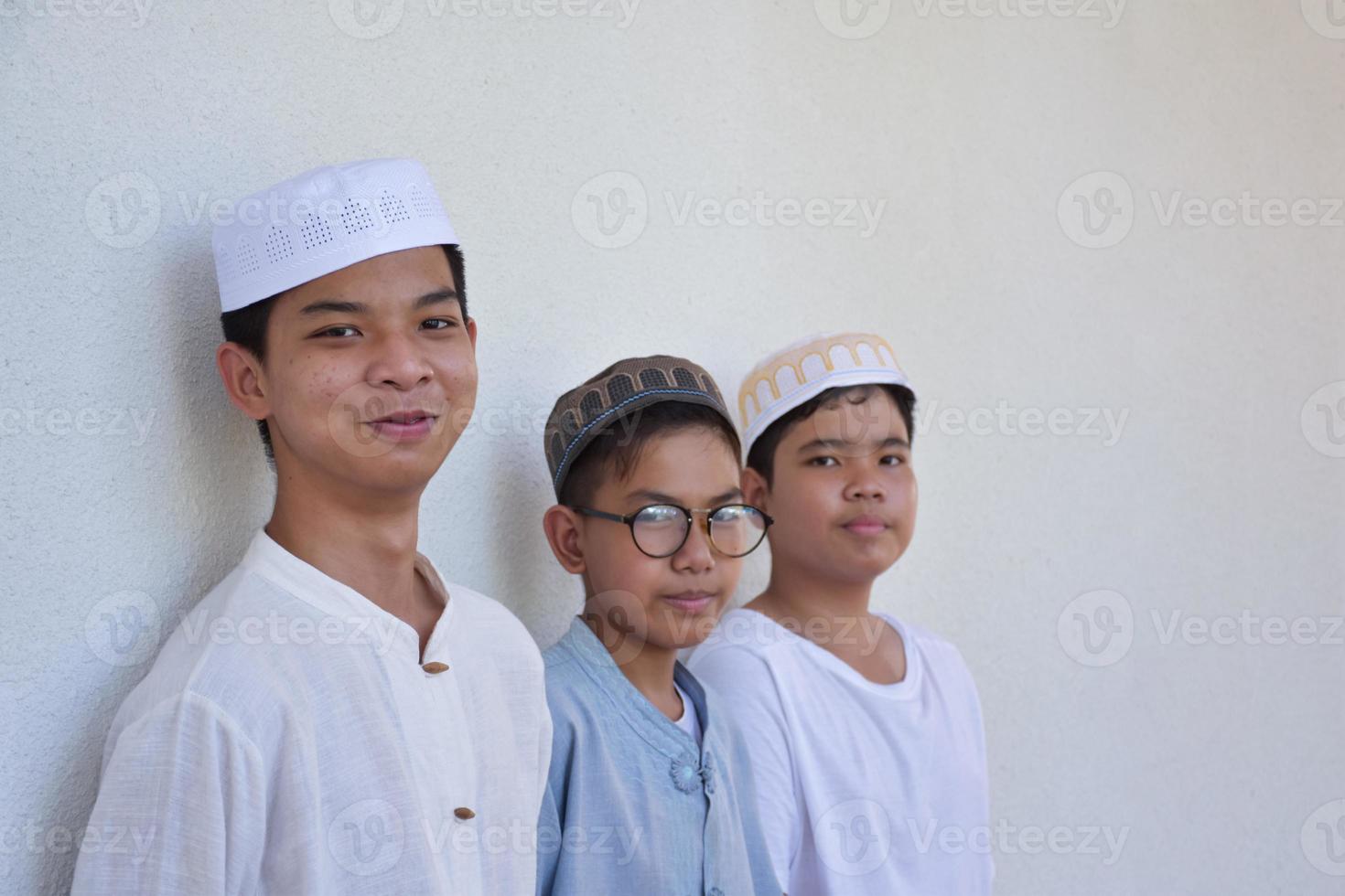 Young southeast asian children standing in a row in front of balcony and waiting to do their daily activity, soft and selective focus. photo