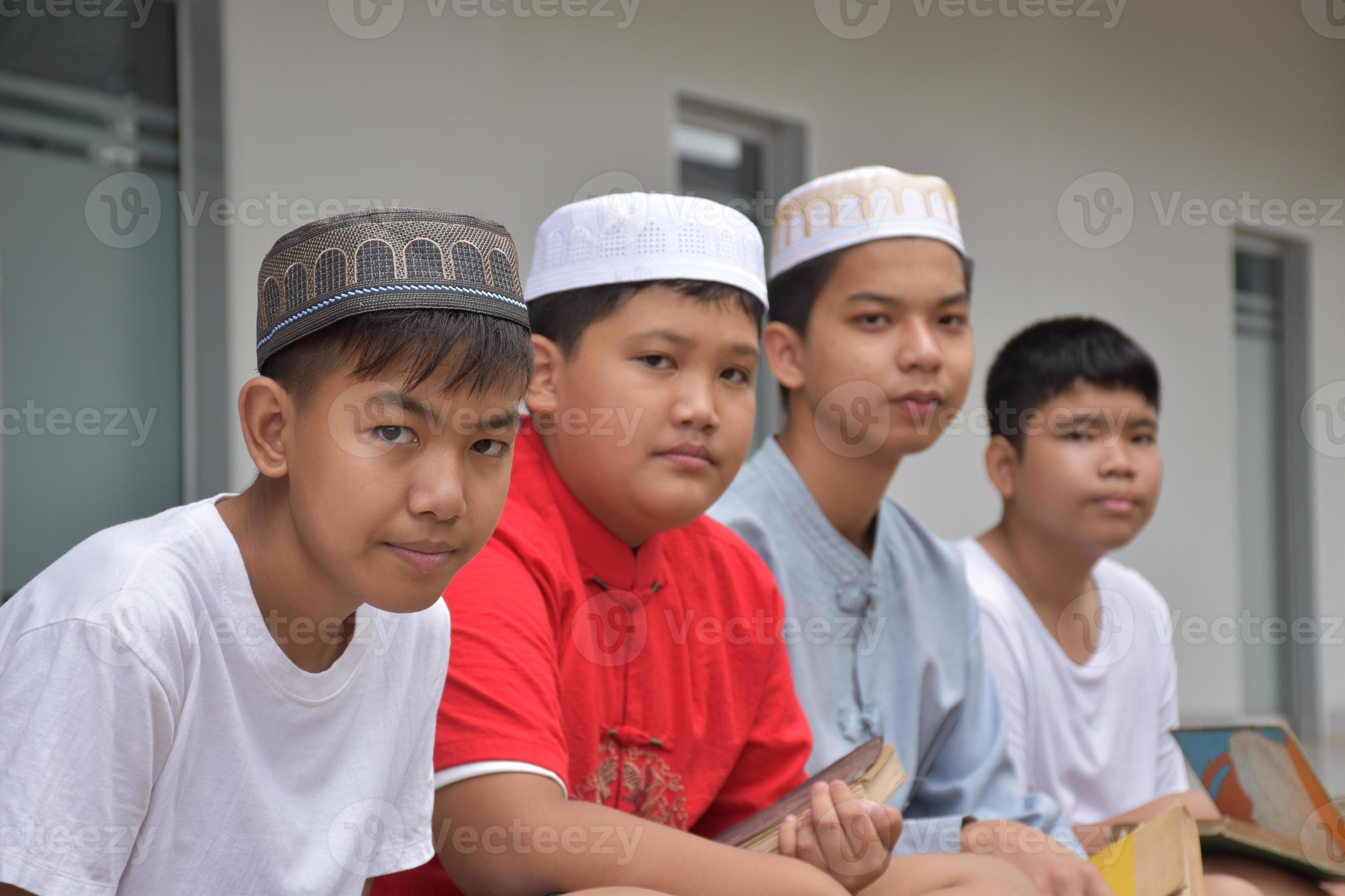 Asian muslim or islamic boys sitting with muslim boys in a row to pray or  to do the religious activity, soft and selective focus. 15224122 Stock  Photo at Vecteezy