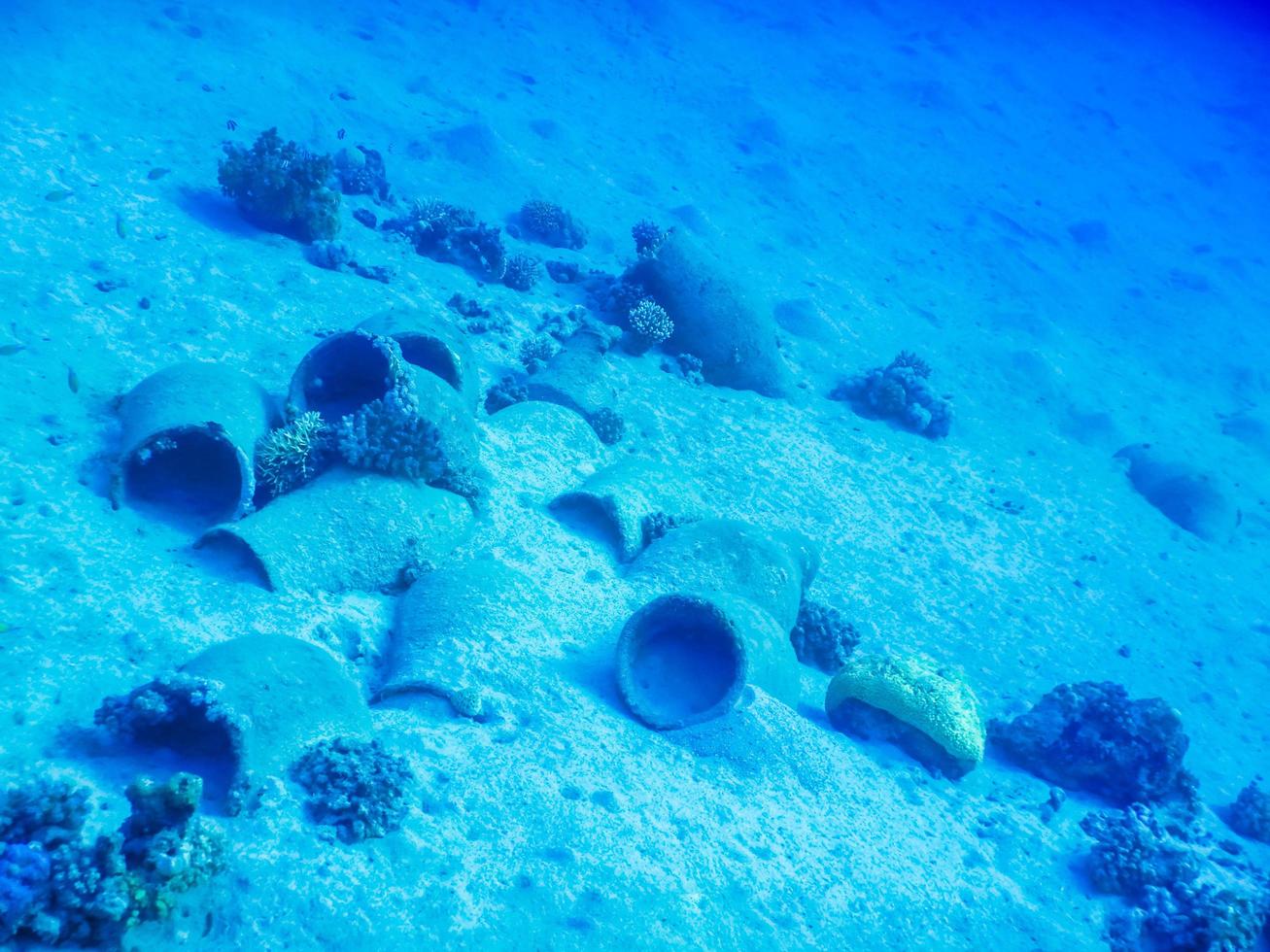lot of old amphorae on the sandy seabed in the red sea photo