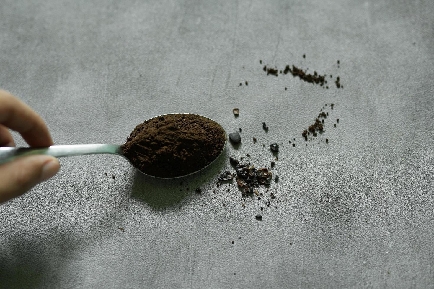 Coffee powder in a spoon ready to be brewed photo