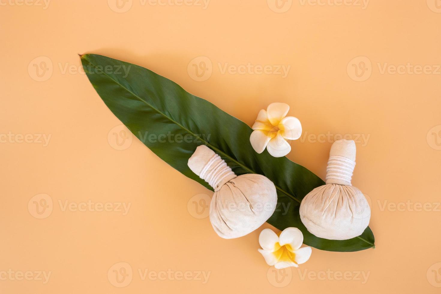 Top view of herbal compress ball with Thai herbal and flower candle. spa background concept. photo