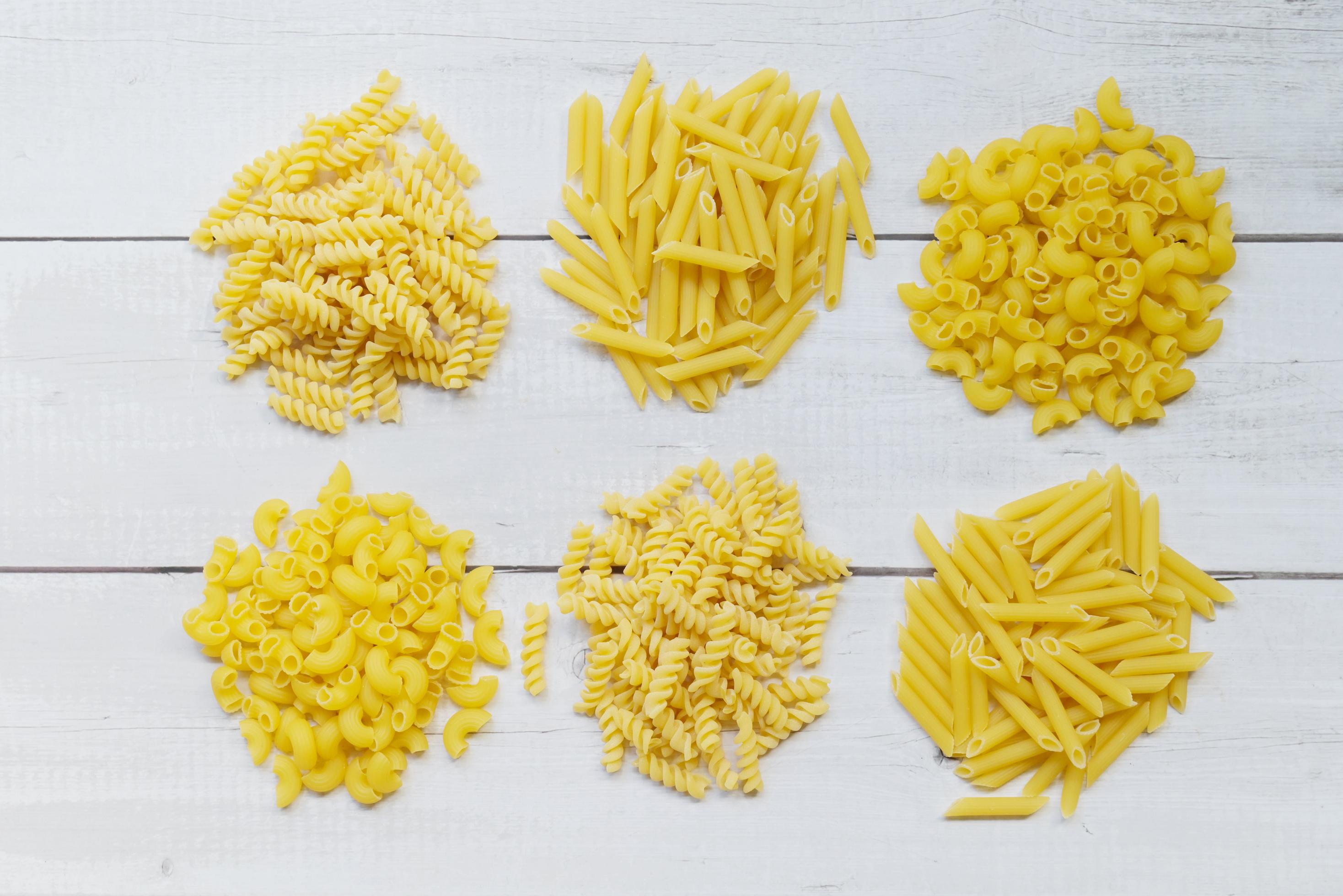 Raw pasta various kinds of uncooked pasta macaroni spaghetti and