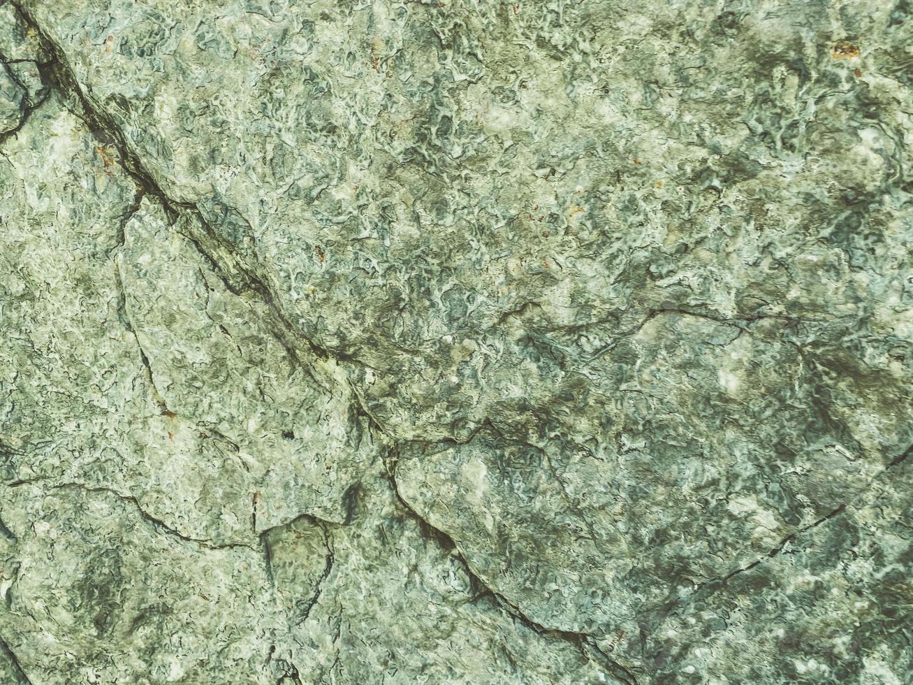 mountain texture. volumetric 3d background with a rock of stones and sand. rock with holes and burrows. solid stone, natural materials background photo