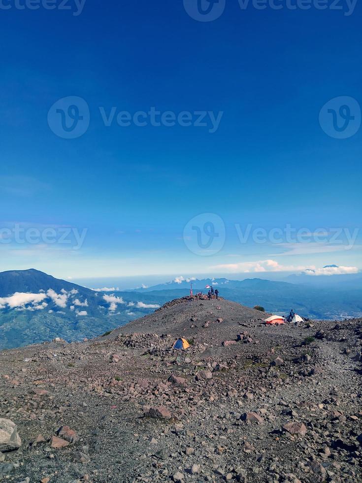 the view above the cloud tops of Mount Marapi, West Sumatra, with a bright blue sky as a background photo