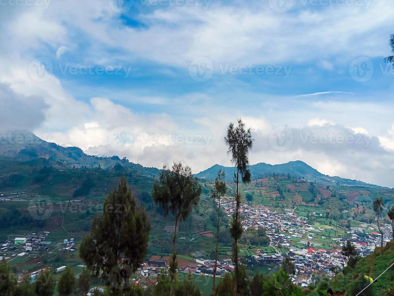 the village in the middle of the potato fields seen from the top of the hill in the Dieng plateau area photo