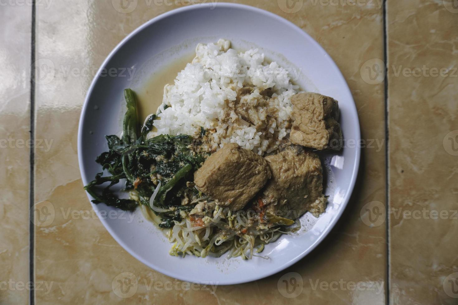 Letok or sambal tumpang, Looks similar with pecel, traditional food from East and Central Java, Indonesia served with rice, tofu, boiled vegetables and eggs. photo