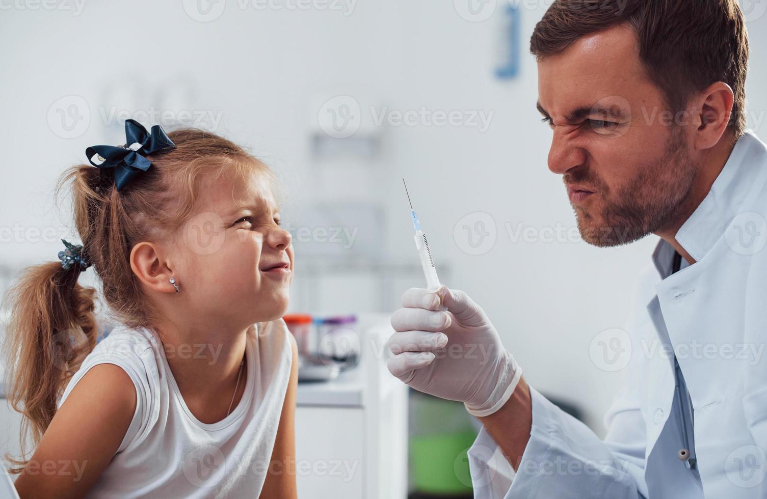 Blood sampling. Little girl is in the clinic with doctor photo