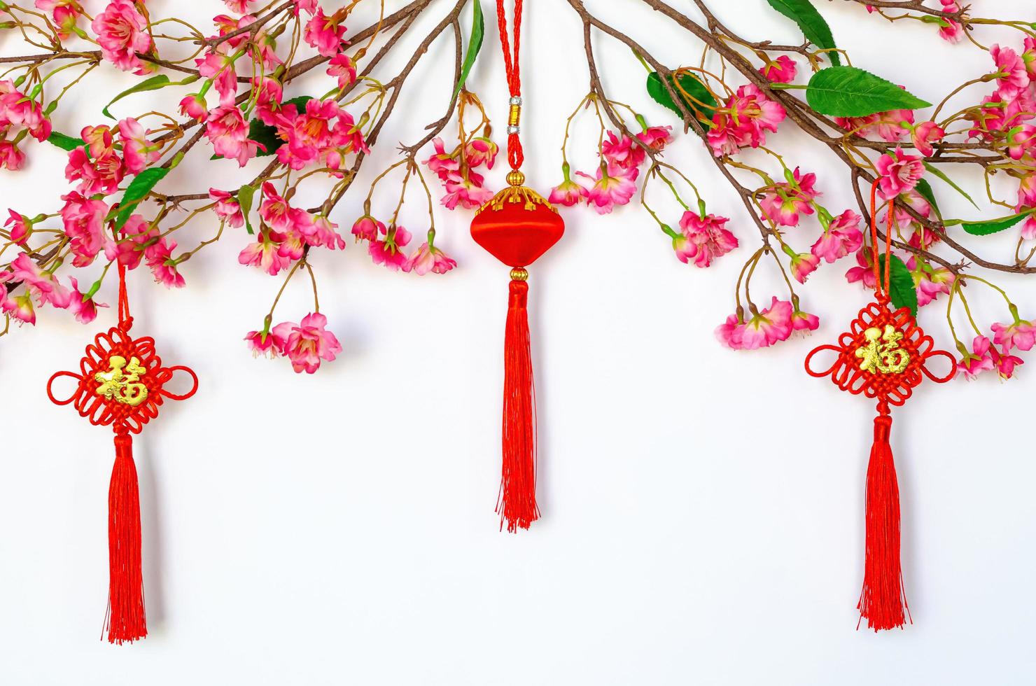 Hanging pendants for Chinese new year ornament meaning of word is wealth with Chinese blossom flowers on white background. photo