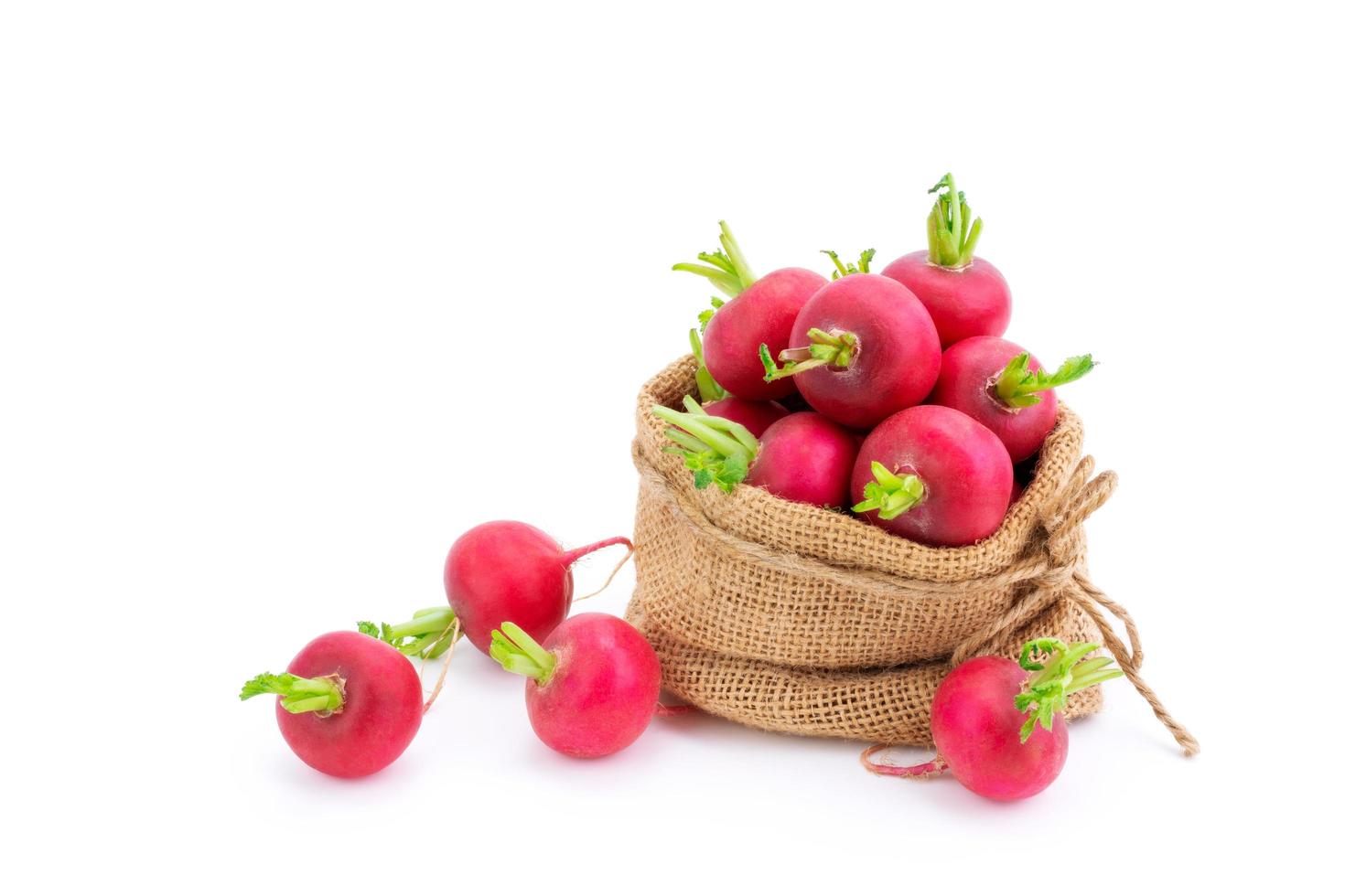 Red or purple radish in burlap bags Organic vegetable salad mix of healthy natural food isolated on white background. photo