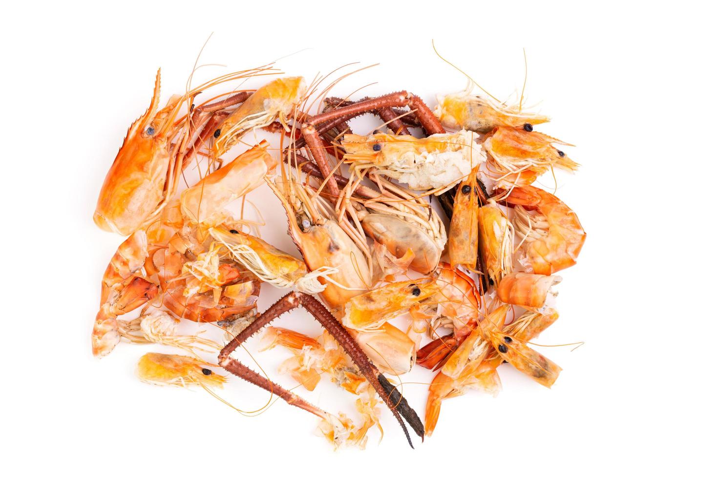 Shrimp heads and shrimp shells, food waste, leftovers, waste. Natural seafood. Lunch. Dinner isolated on white background. photo