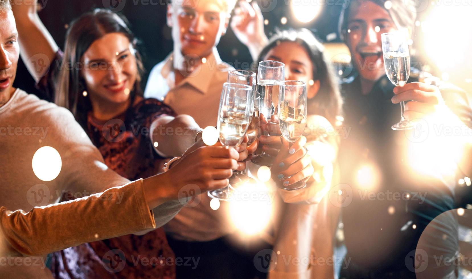 Group of cheerful young people have party and celebrating new year indoors photo