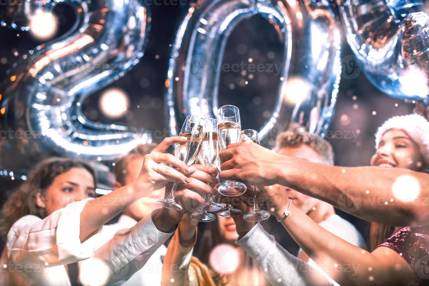 Positive young people holds balloons with new 202 year and celebrating photo