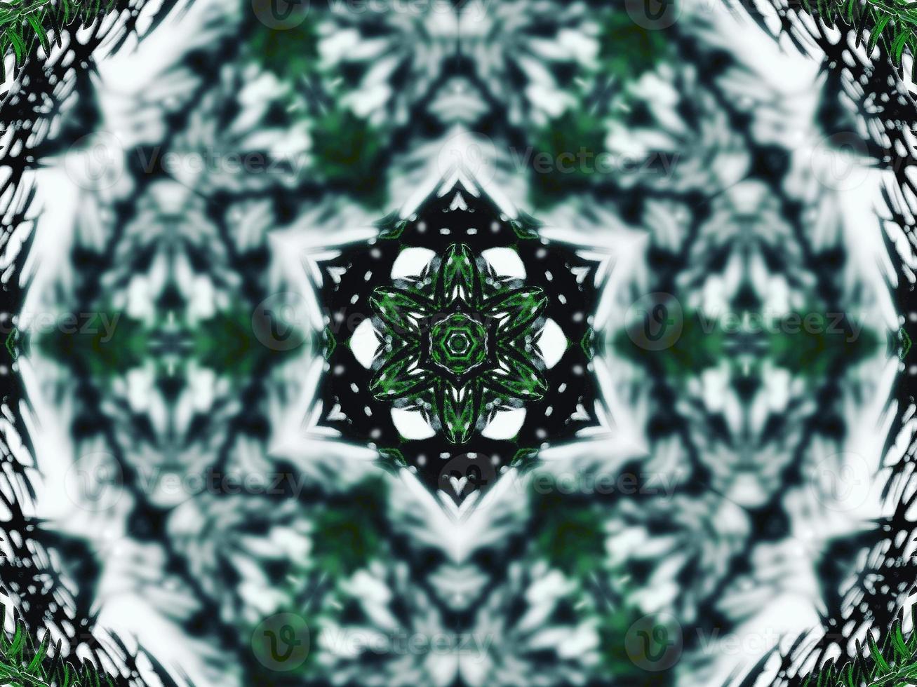 Blurry green leaves kaleidoscope background abstract flower and symmetric pattern for christmas vibes photo