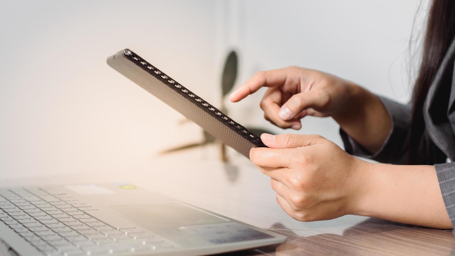 Woman's hands use tablet and laptop to shop online. Authentication in Internet banking on a smartphone and computer. photo